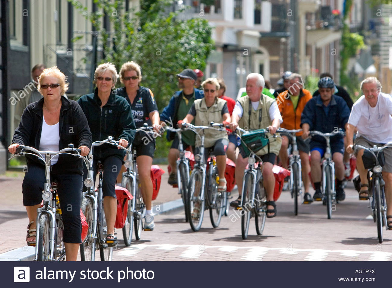people-riding-bicycles-on-the-street-in-amsterdam-netherlands-AGTP7X