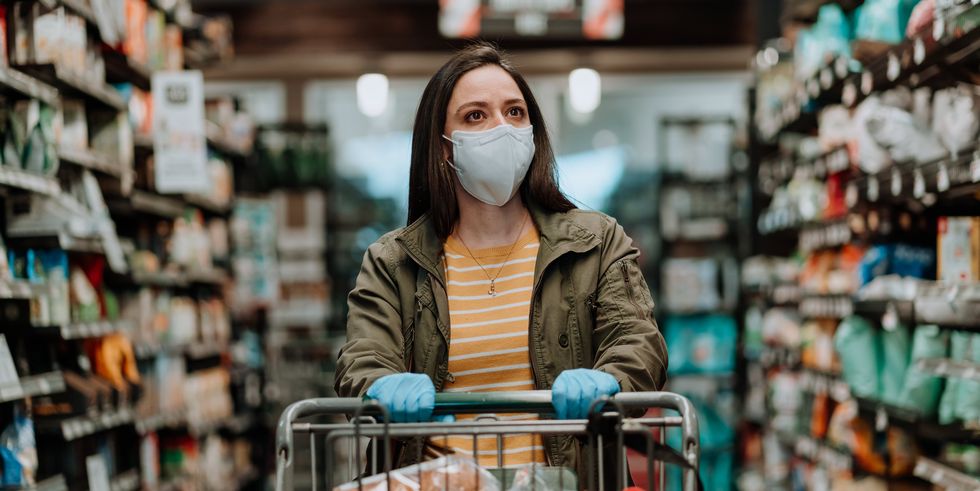 woman-pushing-supermarket-cart-during-covid-19-royalty-free-image-1591304539